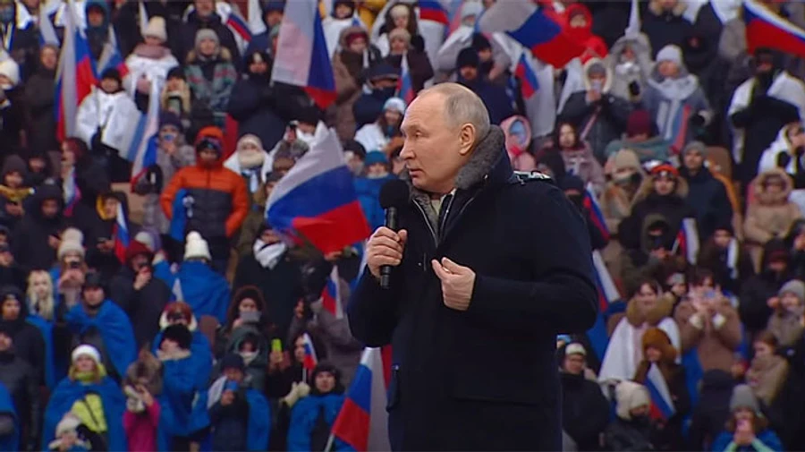 Putin references Lord's prayer in speech at rally and says fighting is ongoing