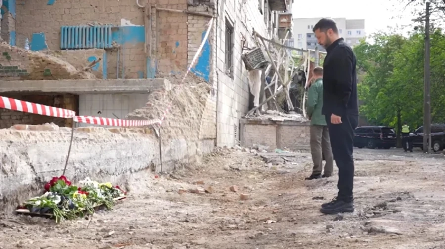 Zelenskyy lays flowers at Kyiv apartment building where Russian missile killed 23 people – video