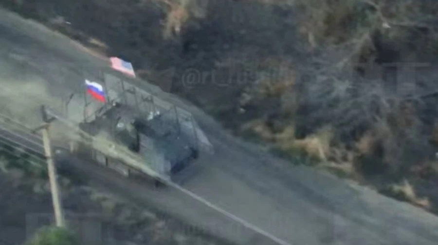 Kremlin propaganda video shows Russians charging into battle in captured vehicle flying US flag – video