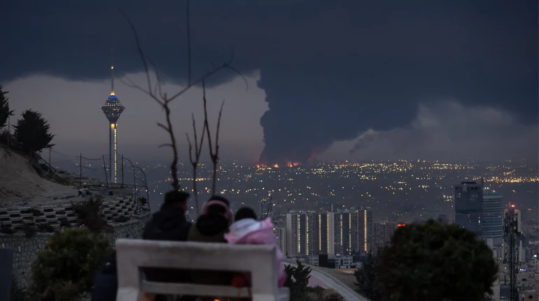 Sky over Tehran covered in thick smoke after strikes on oil depots, black rain reported