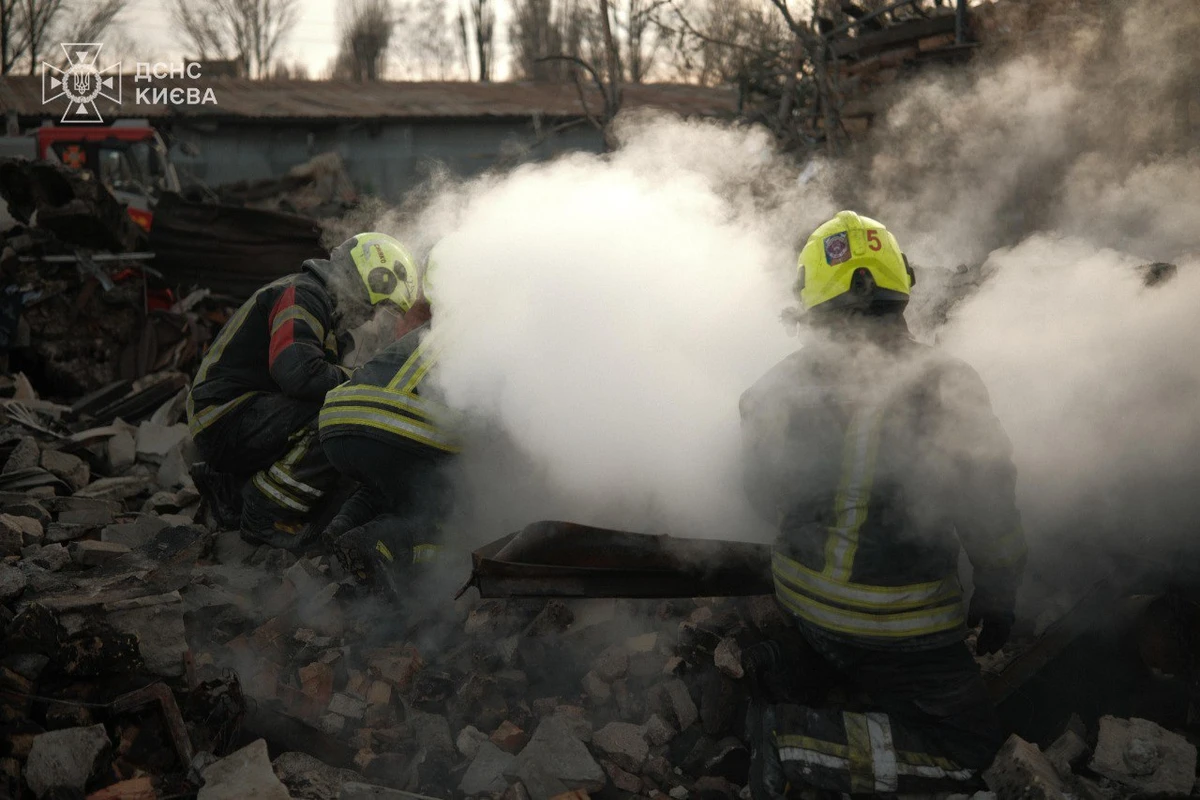 Firefighters work at the site of a destroyed building in Kyiv as a result of a Russian strike.