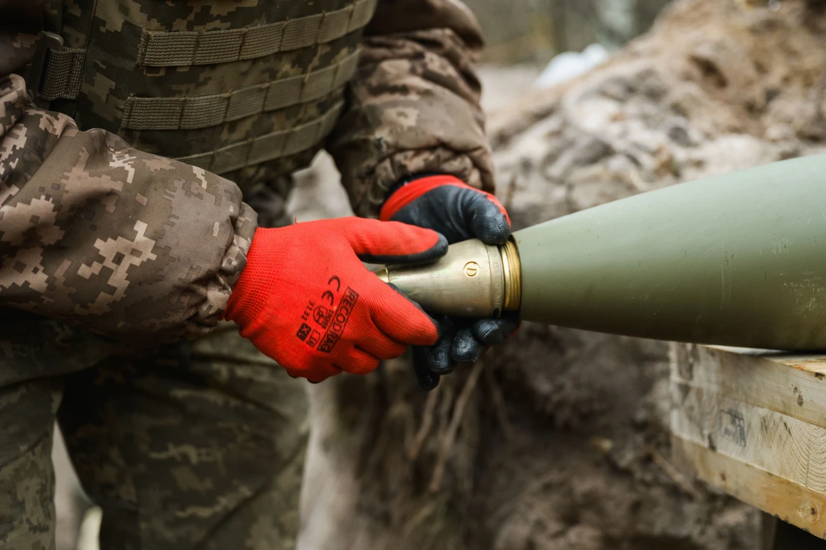 The shell handler screws the fuze onto the shell.