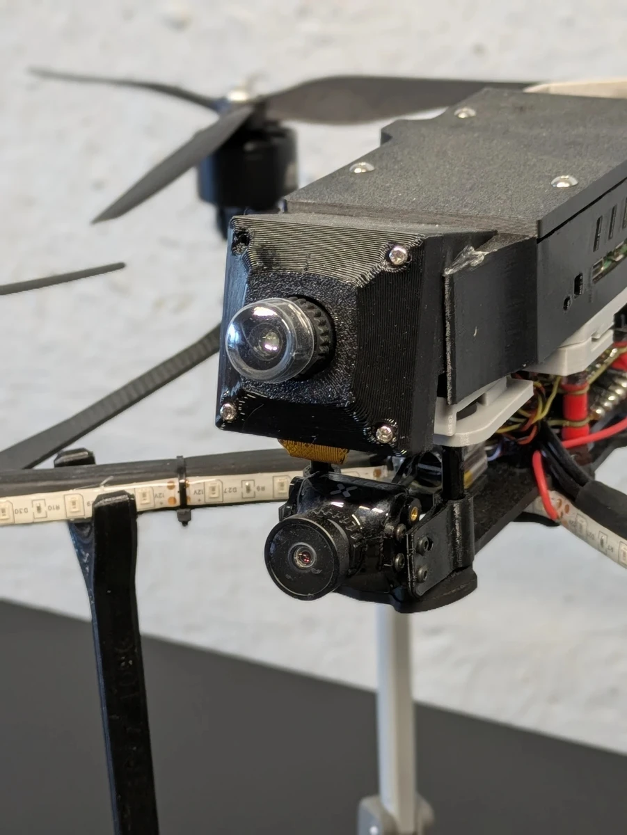 An FPV drone equipped with two cameras for laser beam guidance.