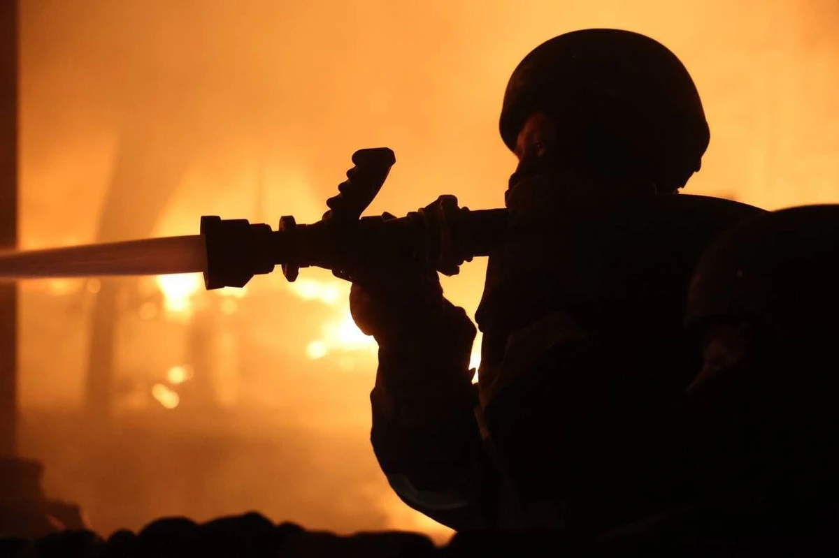 A firefighter extinguishing a fire caused by the Russian attack