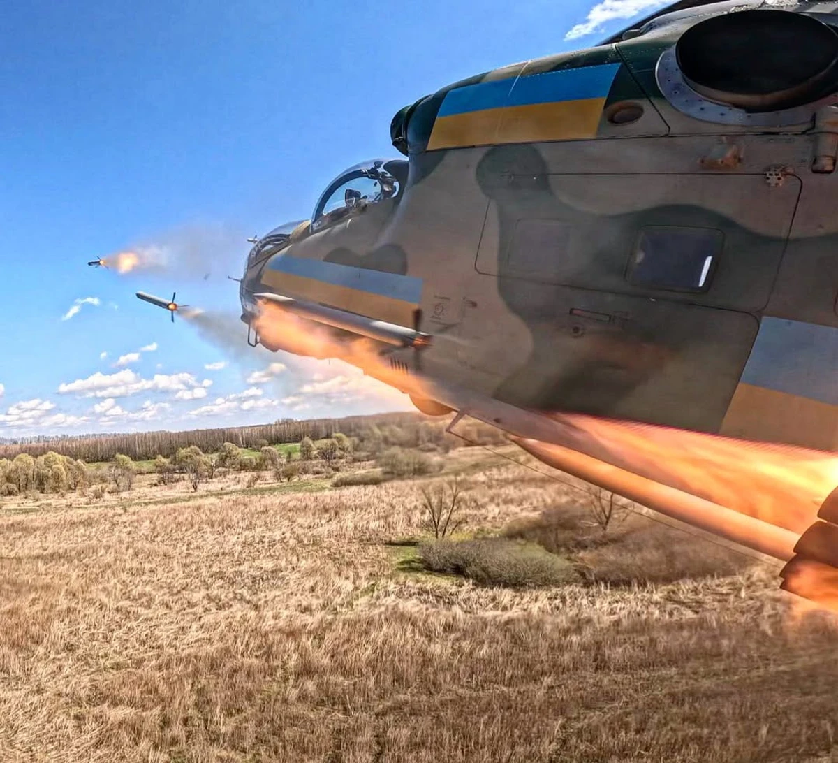 A Ukrainian Mi-24 helicopter performs a rocket-lofting manoeuvre while firing S-8 rockets