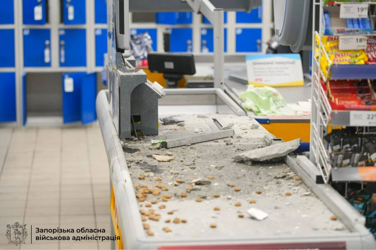 Debris and dust litter a supermarket checkout conveyor belt.