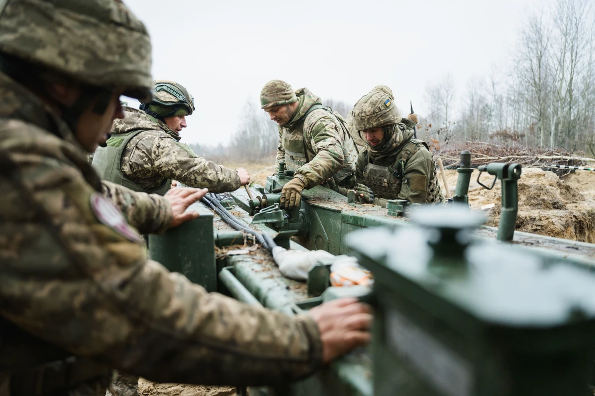 The gun crew deploys the artillery piece into its firing position.