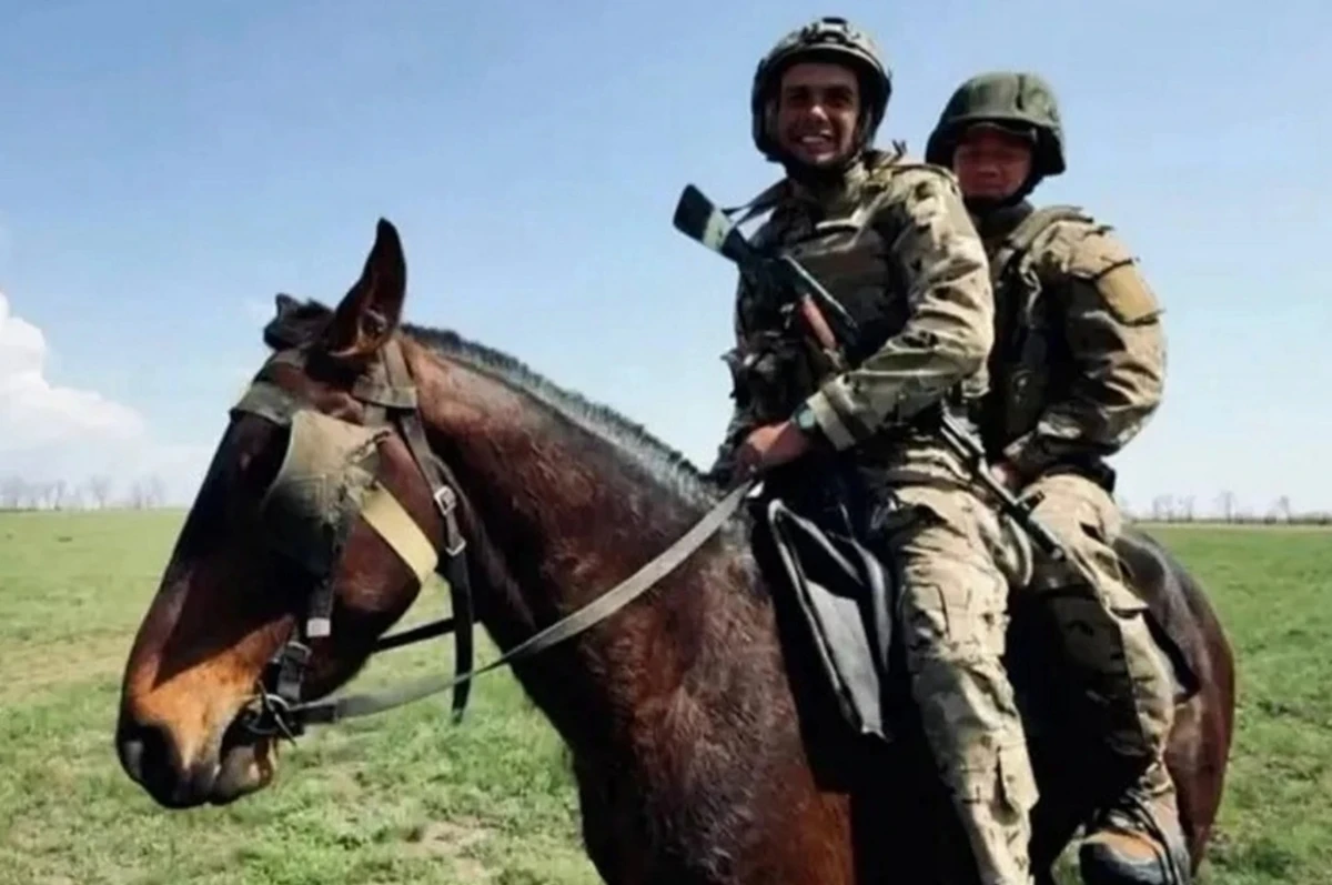 Russian military personnel moving on horseback in a combat zone.