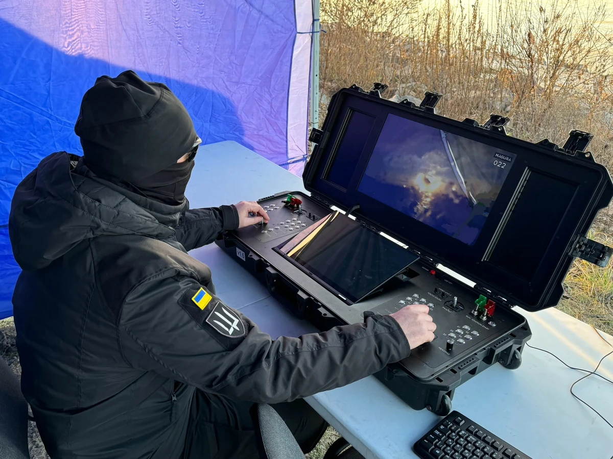 Thirteen at a console for controlling a Magura drone