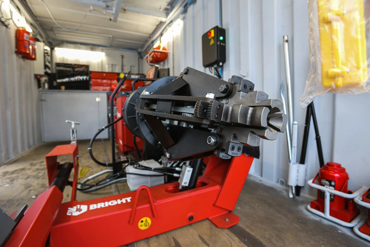 Tyre mounting machine inside a shipping container.