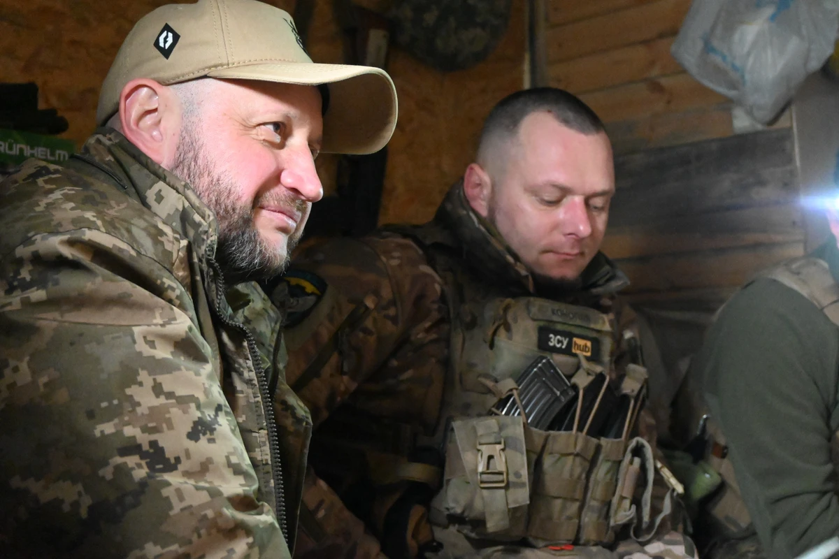 Ukrainian soldiers in a dugout read letters from American schoolchildren