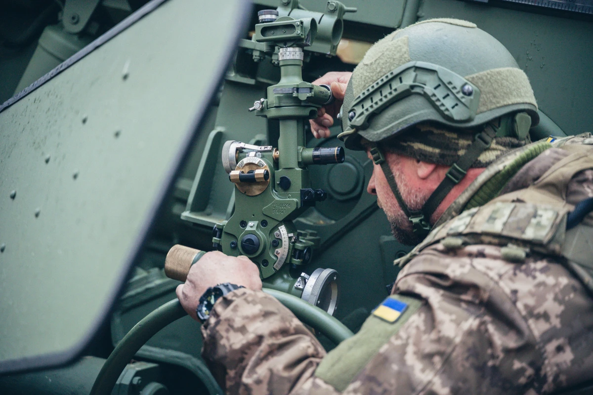 The gunner adjusts the weapon using a panoramic sight.