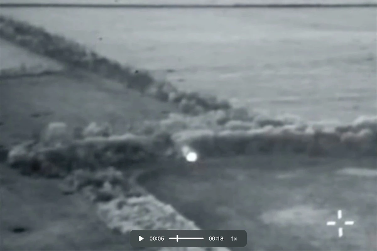 Ground robotic system with infrared illumination seen through a UAV lens.