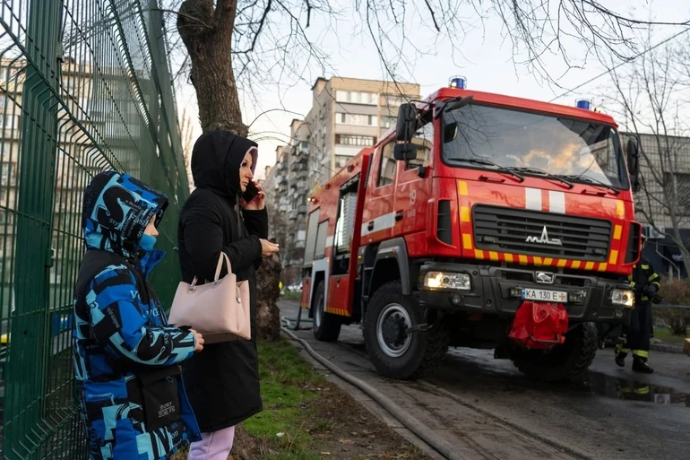 People waiting at the site of the attack.
