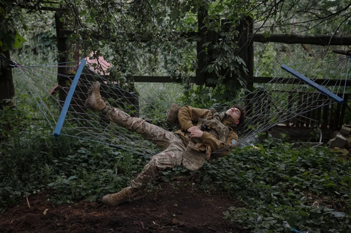 A Ukrainian soldier sleeping in a hammock.