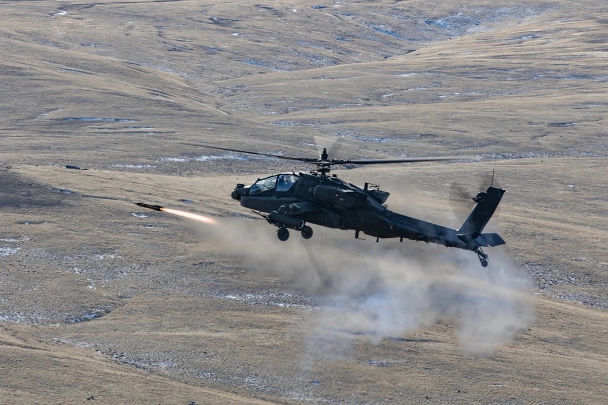 An AH-64E Apache attack helicopter from the 1st Attack Battalion, 229th Aviation Regiment, 16th Combat Aviation Brigade, fires an AGM-114 Hellfire guided missile during a training exercise at the Yakima Training Center in Washington state