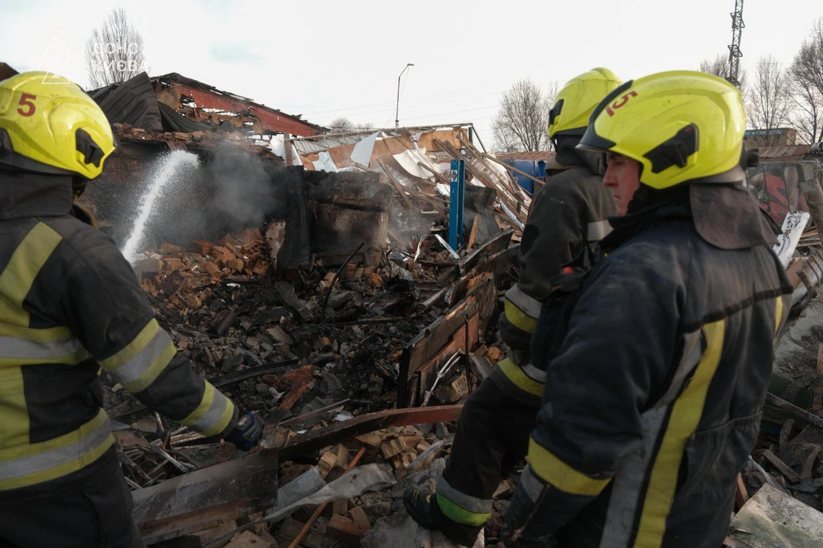 Firefighters work at the site of a destroyed building in Kyiv as a result of a Russian strike.