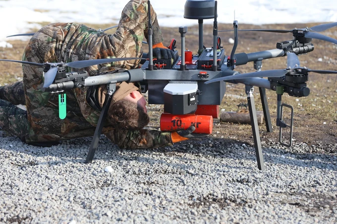 A technician prepares a drone for take-off