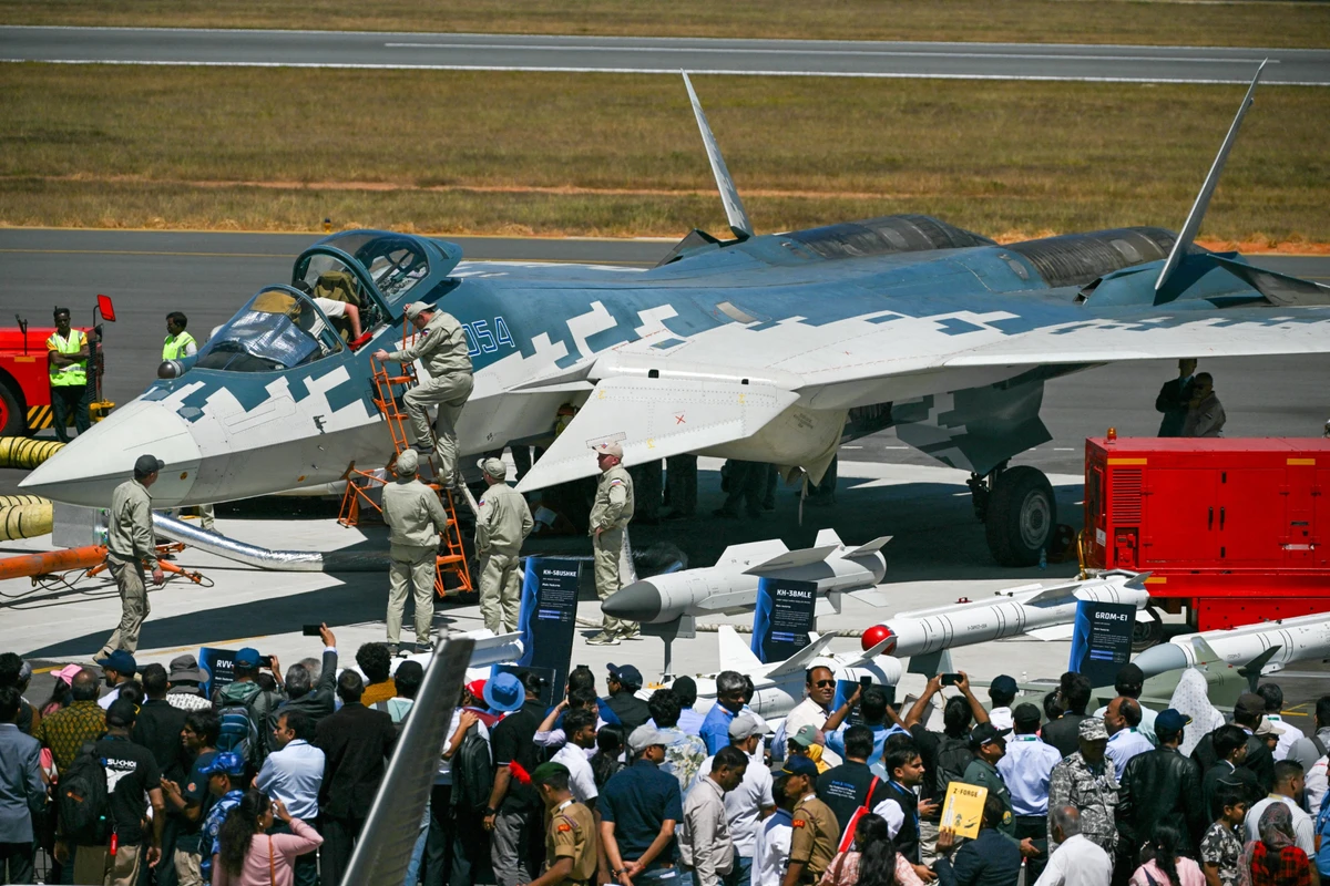 A Su-57 fighter at the Aero India 2025 air show alongside mock-ups of its weapons.