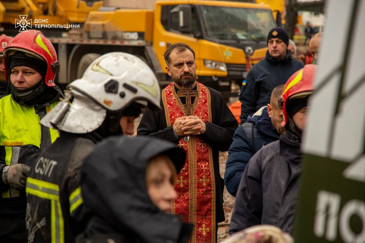 A priest prays at the site of the attack.