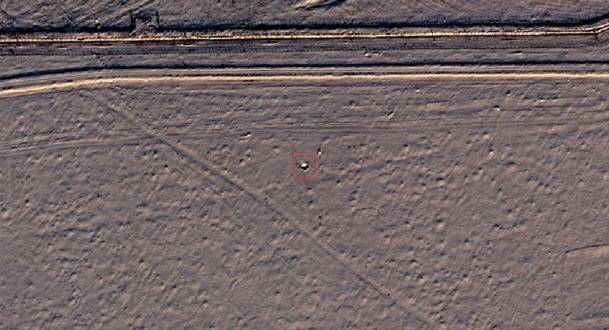 The crater from the remains of the Flamingo missile near the perimeter fence of Site No 105.