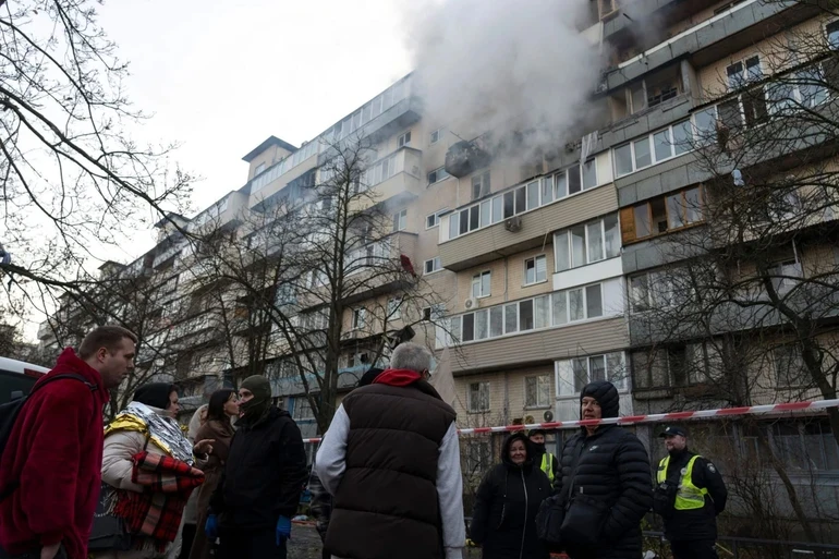 People waiting at the site of the attack.