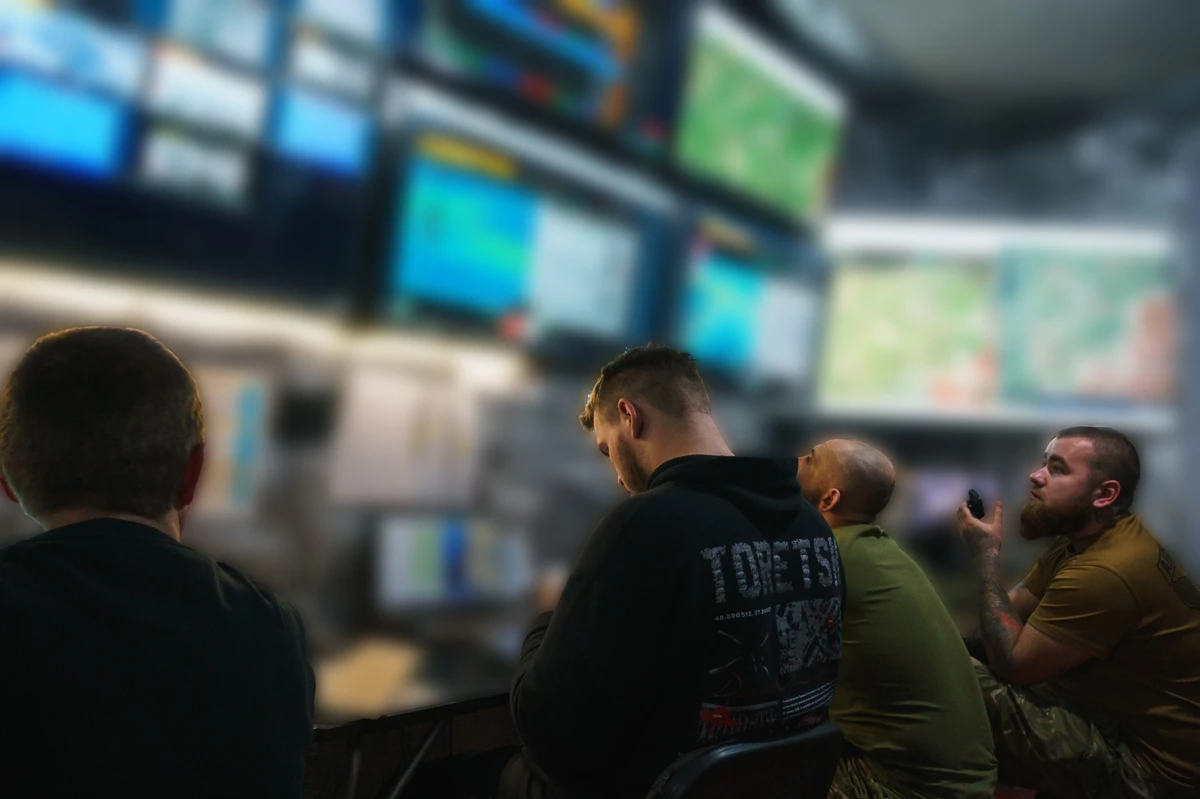 Dozens of live feeds of the contact zone are displayed at workstations.