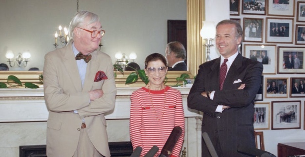 Рут Бейдер Ґінзбурґ — правниця, адвокатка, суддя та поп-ікона, яка сприяла соціальному та юридичному визнанню рівності статей. Чоловік у темному костюмі біля Рут — майбутній 46-й Президент США Джо Байден. На той момент — 1993 рік — сенатор Байден очолював Комітет із правосуддя, який оцінював кваліфікації пані Ґінзбурґ задля можливого призначення її на посаду судді Верховного суду. Сенат підтримав кандидатуру Рут 96 голосами проти 3