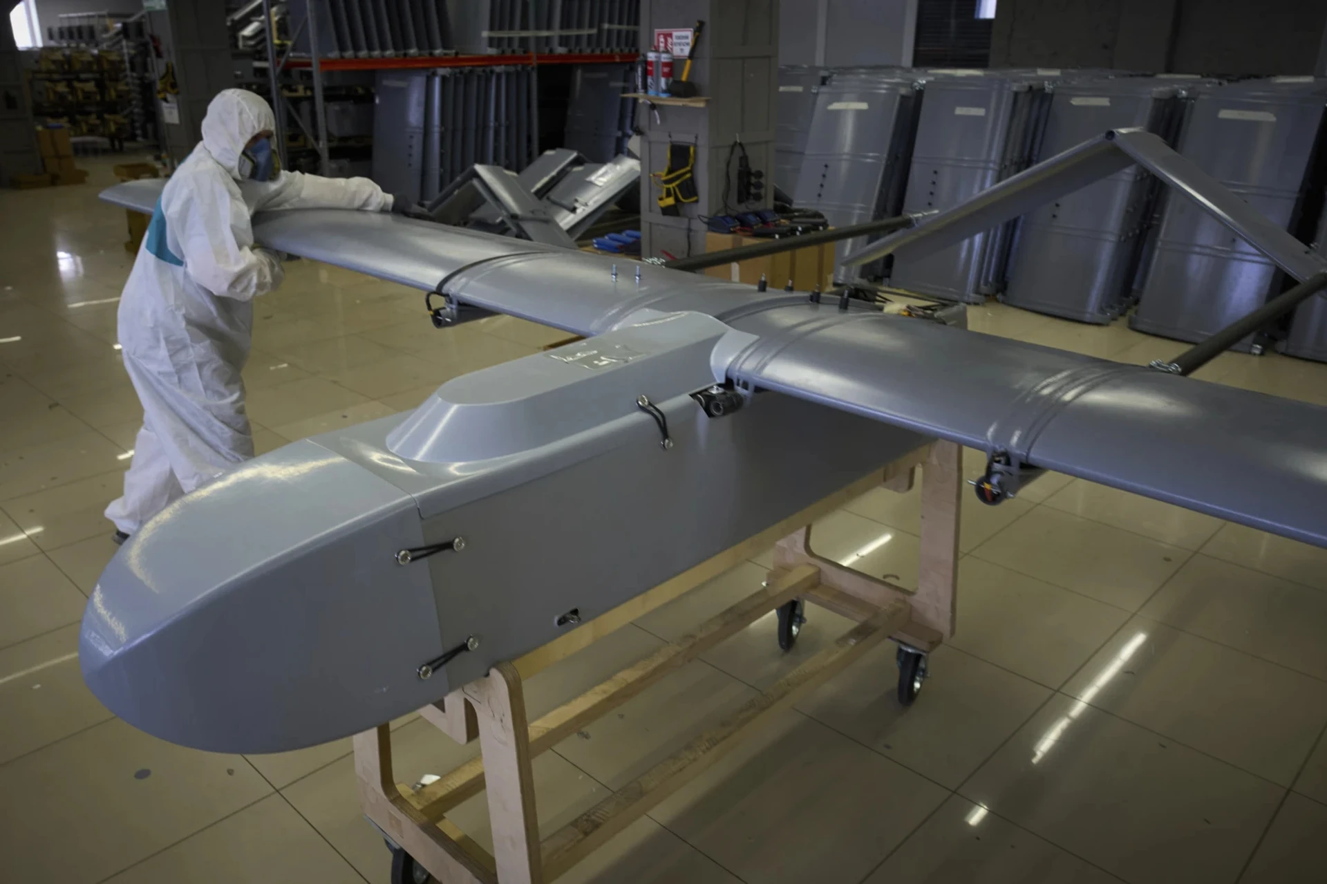 A military drone being inspected. 